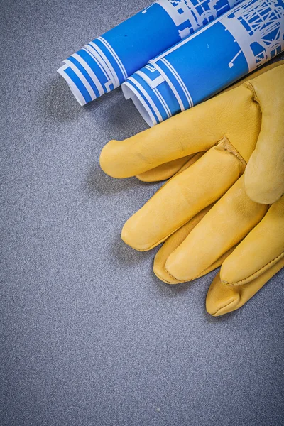 Leather gloves and engineering drawings — Stock Photo, Image