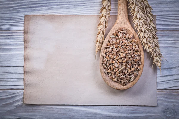 Wheat ears, spoon and vintage paper — Stock Photo, Image
