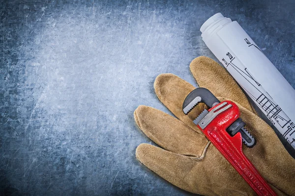 Monkey wrench, protective glove and blueprints — Stock Photo, Image