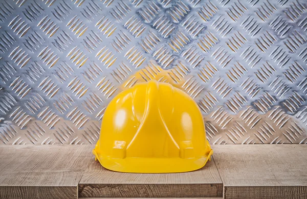 Safety hard hat wooden board channeled metal sheet construction — Stock Photo, Image