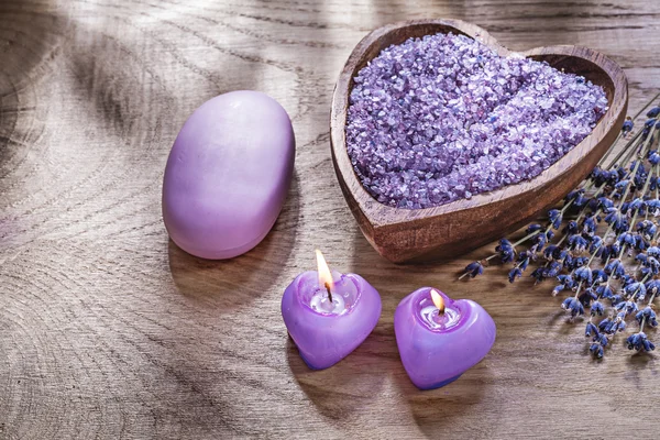 Composition of candles wooden spoon sea salt scented lavender pi — Stock Photo, Image