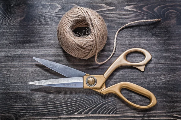 Golden scissors and hank of rope — Stock Photo, Image