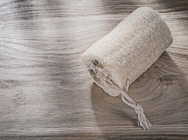 Scrubbing loofah on wooden board — Stock Photo, Image