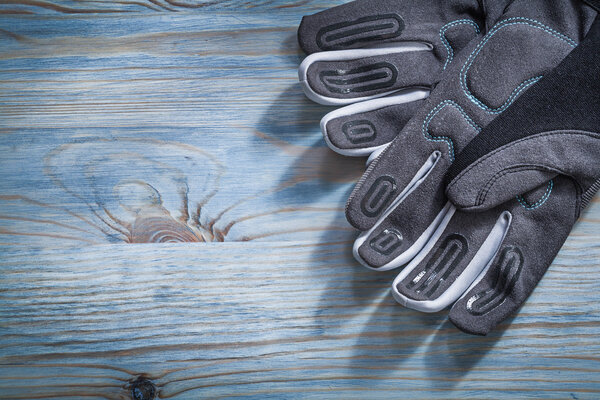 Safety gloves on wooden board 