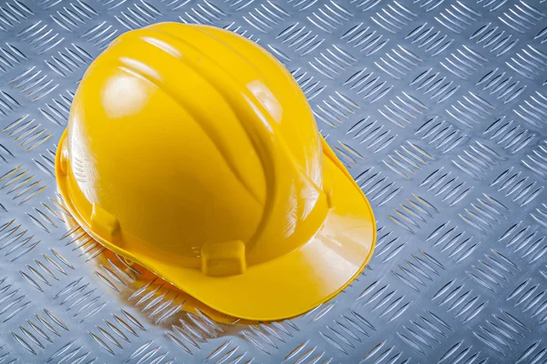 Hard hat on grooved metal plate — Stock Photo, Image