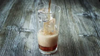 Kaliteli ahşap arka planda duran buzlu kolayı cama dökmek