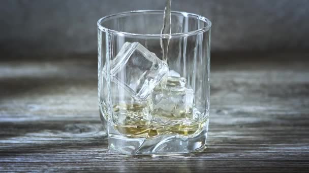 Whiskey Poring Transparent Glass Ice Cubes Vintage Wooden Background — Stock Video