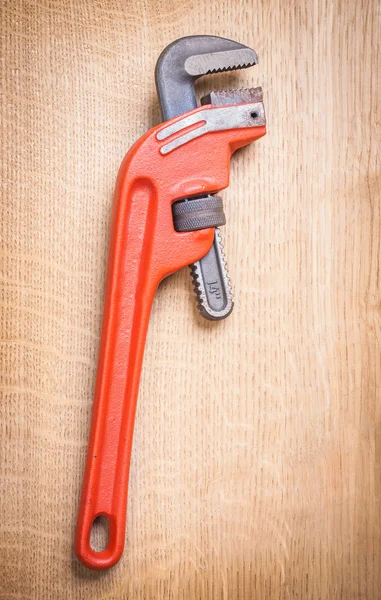 Pipe wrench on wooden board — Stock Photo, Image