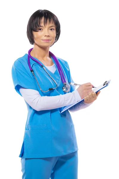 Asian female doctor writing in clipboard — Stock Photo, Image