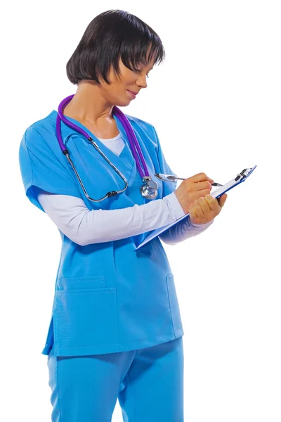 Asian female doctor writing in clipboard and looking on it isola — Stock Photo, Image