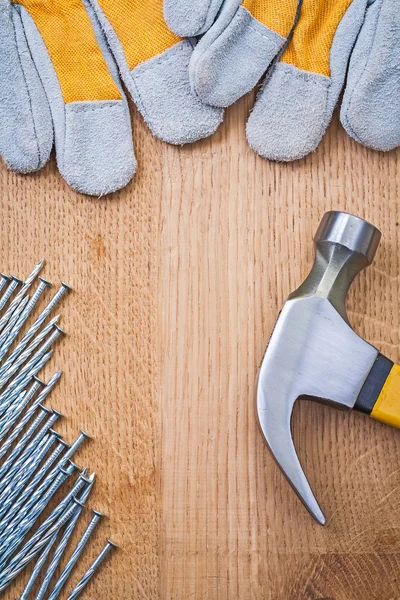 Copyspace image claw hammer nails protective gloves on wooden bo — Stock Photo, Image