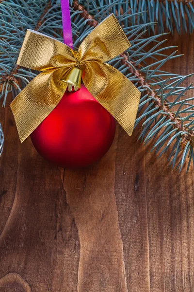 Red christmas bauble and gold bow — Stock Photo, Image