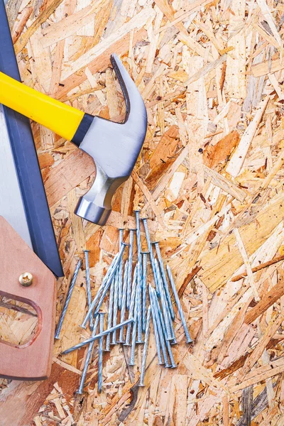 Handsaw claw hammer and nails — Stock Photo, Image