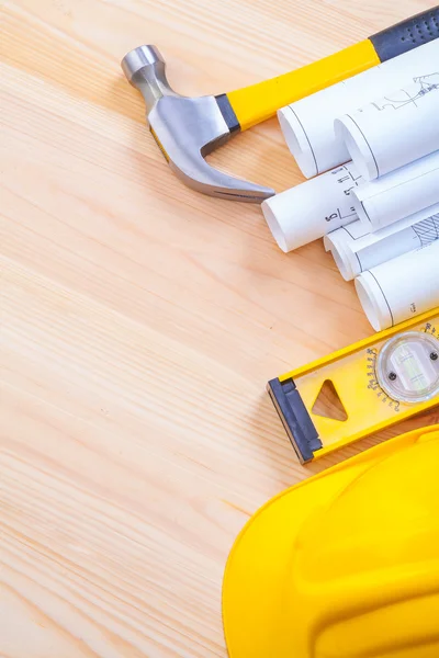 Blueprints with helmet and hammer — Stock Photo, Image