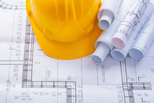 Construction helmet and blueprints — Stock Photo, Image