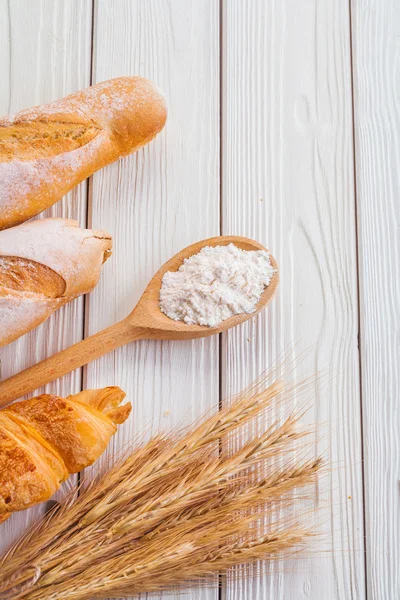 Baguettes and ears of wheat — Stock Photo, Image