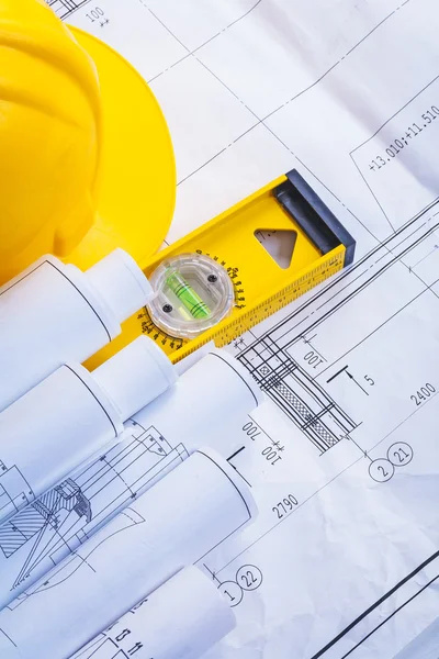 Construction level, helmet, blueprints Royalty Free Stock Photos