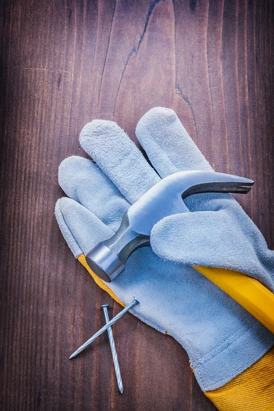 Claw hammer on glove and nails — Stock Photo, Image