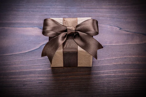 Square gift box with brown ribbon