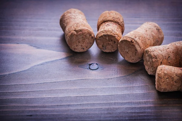 Champagne corks on wooden board Stock Photo