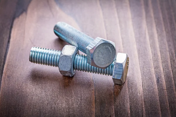 Botls and nut on vintage wooden board — Stock Photo, Image