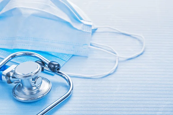 Masks and stethoscope on blue background — Stock Photo, Image