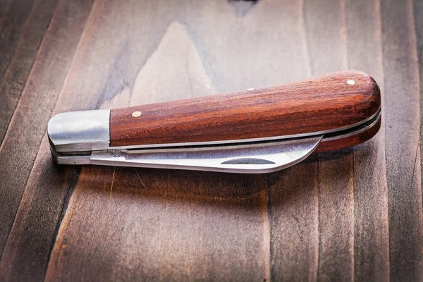 Cuchillo agrícola sobre tabla de madera — Foto de Stock