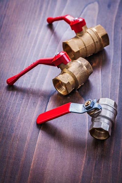 Three plumbers fixtures with red handles — Stock Photo, Image