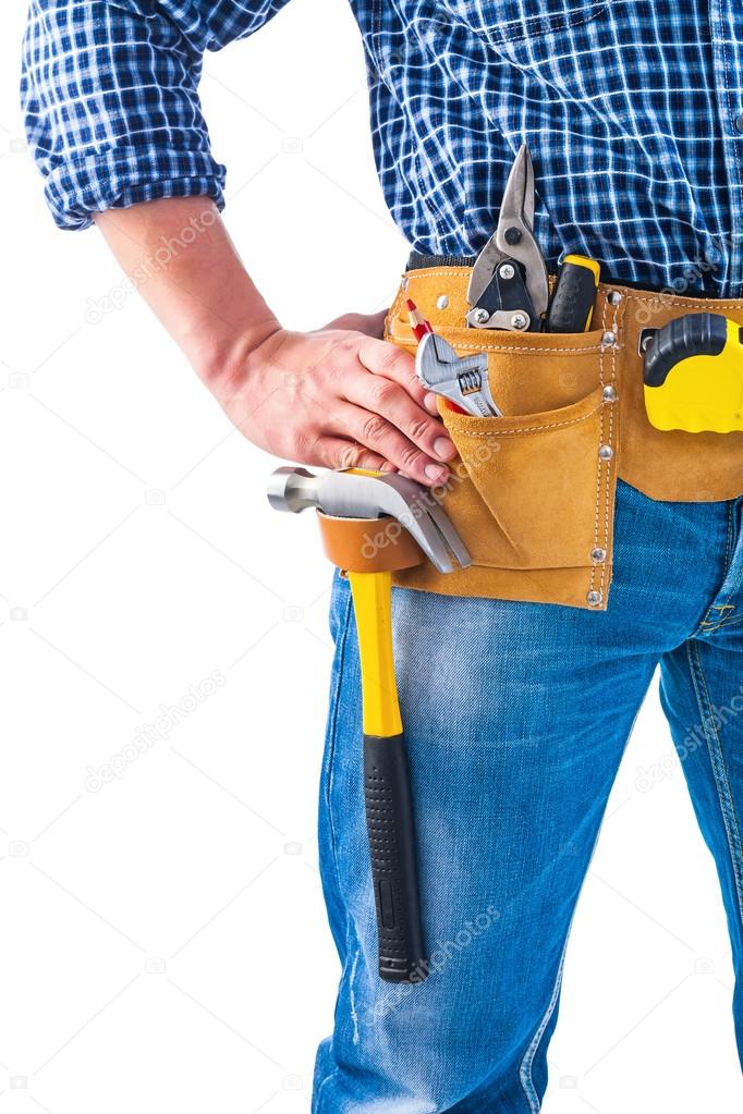 Carpenter holding hand on toolbelt
