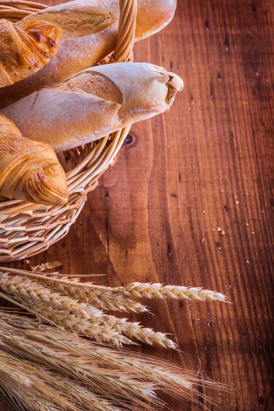 Baguettes and croissants in wicker basket — Stock Photo, Image