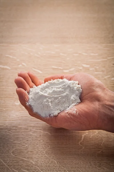Hand holding heap of flour — Stock Photo, Image