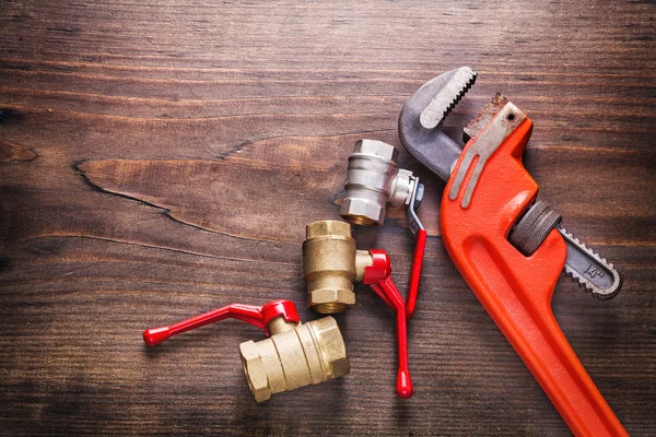 Two plumbers fixtures and monkey wrench — Stock Photo, Image