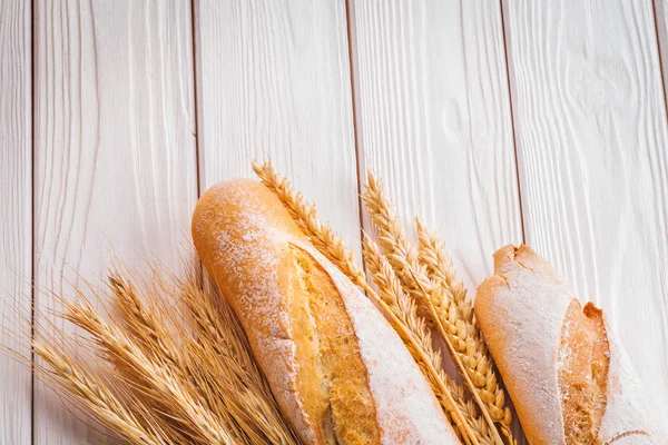 Baguettes and ears of wheat rye — Stock Photo, Image