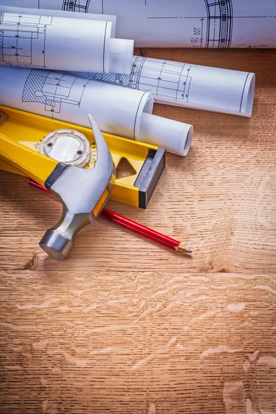 Rooled blueprints on wooden board co — Stock Photo, Image