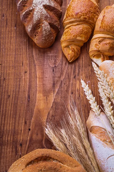 Bread on wooden background — Stock Photo, Image