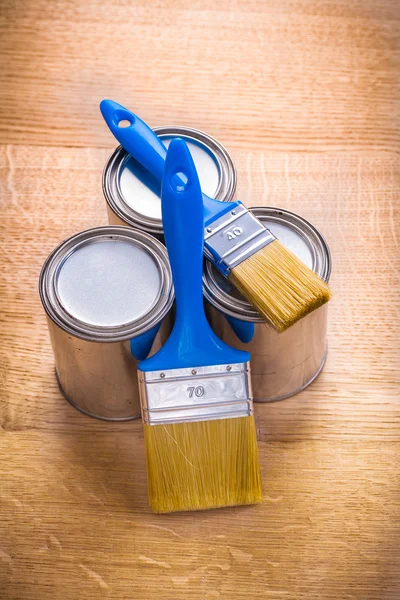 Two paint brushes and three cans — Stock Photo, Image