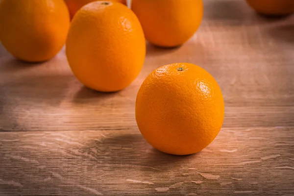 Orange fruits on board — Stock Photo, Image