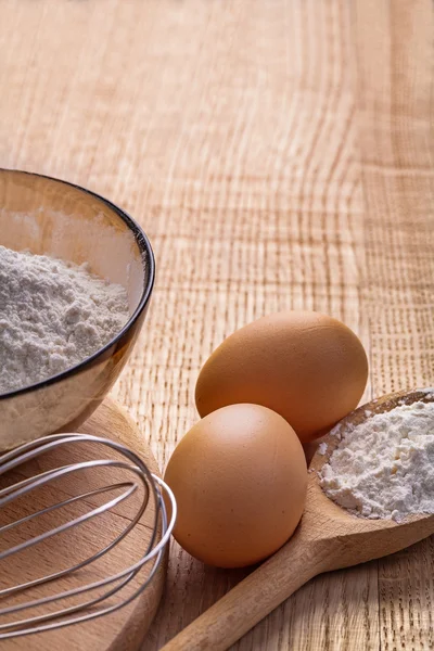 Flour in bowl on vintage wooden board — Stock Photo, Image