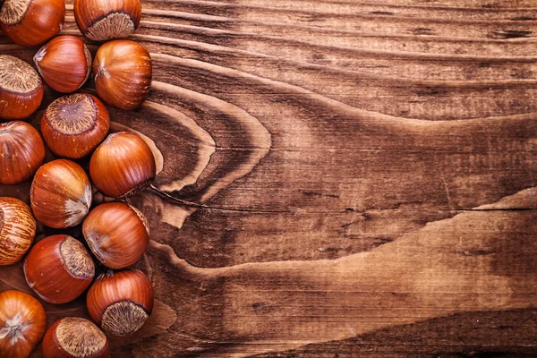 Hazelnuts on vintage wooden board food — Stock Photo, Image