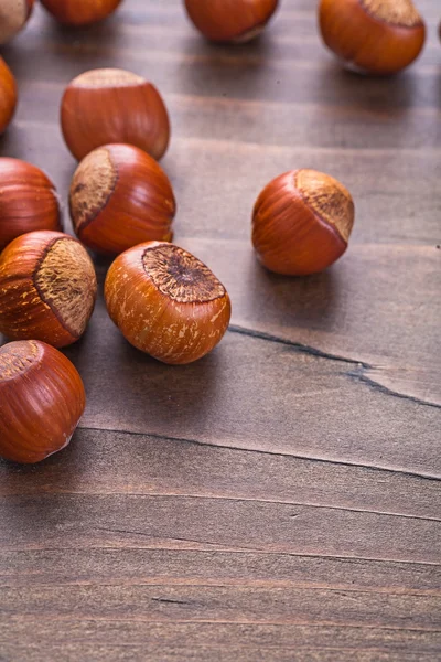 Tasty hazelnuts on wooden board — 图库照片