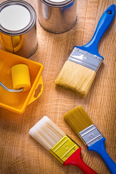 Paint brushes on wooden board — Stock Photo, Image