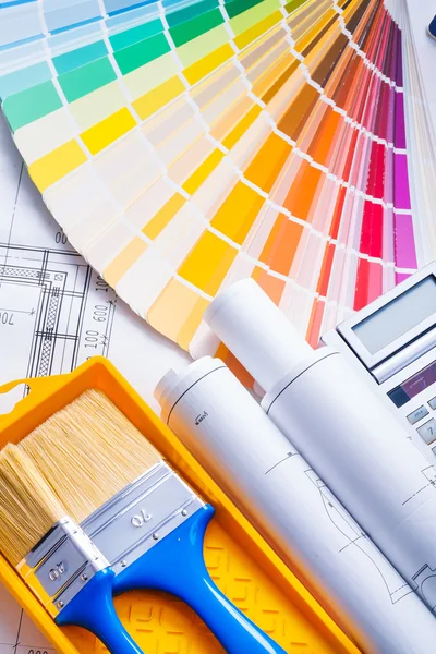 Rolled blueprints and paint brushes — Stock Photo, Image