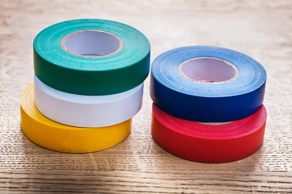 Rolls of insulating tape on wooden board — Stock Photo, Image