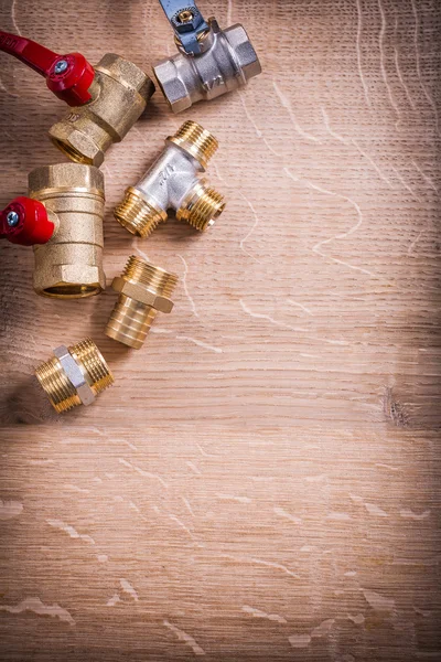 Brass Pipe Connectors On Wooden Board — Stock Photo, Image