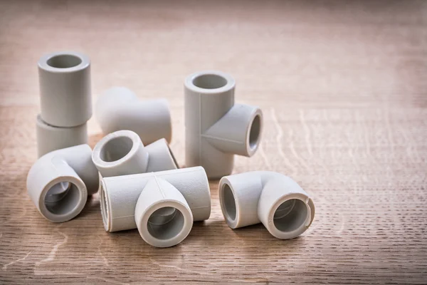 Pipe Fittings On Wooden Board — Stock Photo, Image