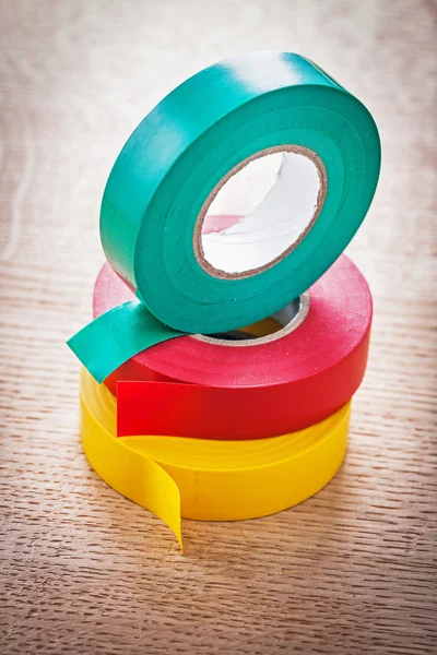 Rolls of insulating tape on wooden board — Stock Photo, Image