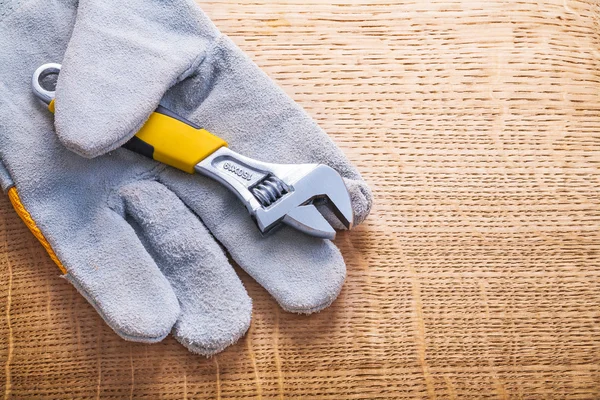 Adjustabe wrench and protective  glove — Stock Photo, Image