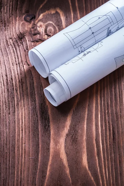 Blueprints on vintage brown wooden board — Stock Photo, Image