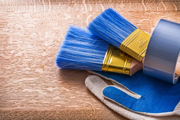 Paint brushes in duct tape on gloves — Stock Photo, Image