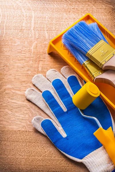 Gloves paint roller tray and brushes — Stock Photo, Image
